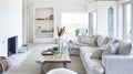 Interior of a living room with white walls, sofa and cushions. Sitting room in coastal cottage with sea view Royalty Free Stock Photo