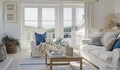 Interior of a living room with white walls, sofa and cushions. Sitting room in coastal cottage with sea view Royalty Free Stock Photo