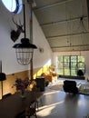 Interior of a loft. Living room with midcentury modern furniture. Concrete floor and plants. Mustard yellow chair