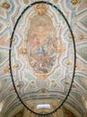 interior of Loreto church in Lisbon with large oval-shaped lamp.