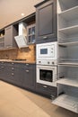 Interior of luxurious wooden modern kitchen grey cabinets Royalty Free Stock Photo