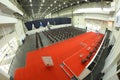 Interior of the main press-conference hall of the International exhibition centre, podium and chairs for people set Royalty Free Stock Photo