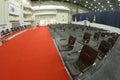 Interior of the main press-conference hall of the International exhibition centre, podium and chairs for people set Royalty Free Stock Photo