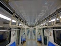 Interior of metro train with empty seats and abstract of handgrip inline