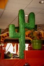 Interior of Mexican Restaurant with Southwestern DÃÂ©cor and a customer with mask and cap looking at phone