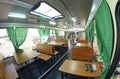 Interior of a military mobile canteen bus for soldiers, cook workplace, seats and tables.
