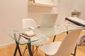 Interior of minimalist office with white walls, wooden floor, wooden and glass computer table and white bookcase with folders. Royalty Free Stock Photo