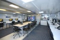 Interior of the mobile emergency control room, meeting table, main monitor, workplaces for dispatchers