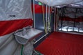 Interior of mobile plastic decontamination shower tent with small steel wash basin