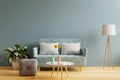 Interior mockup with sofa in living room with empty blue wall background Royalty Free Stock Photo