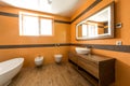 interior of modern bathroom in orange and white Royalty Free Stock Photo