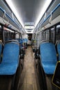 Interior of modern bus or trolleybus. Blue seats inside public transport. Handrails and ticket control system Royalty Free Stock Photo