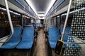 Interior of modern bus or trolleybus. Comfortable blue seats inside public transport. Handrails and ticket control system Royalty Free Stock Photo