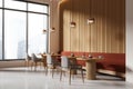 An interior of a modern cafe with wooden furniture, large windows, and a city view, conveying a warm, inviting atmosphere. 3D