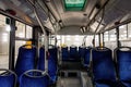Interior of a modern city bus with blue seats Royalty Free Stock Photo