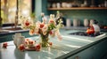 Interior of modern classic kitchen in green tones. Kitchen island with stone countertop and gas cooker, flowers in a Royalty Free Stock Photo