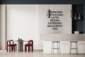 Interior of modern coffee shop with white and dark blue walls, concrete floor, white bar counter with stools, shelves with dishes Royalty Free Stock Photo