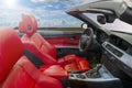 Interior of a modern convertible car with red leather seats