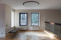 Interior of modern empty space with suspended bench and windows