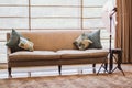 Interior with modern furniture, bright spring studio with a beautiful beige sofa and colored decorative pillows. Beige Royalty Free Stock Photo