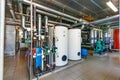 The interior of a modern gas boiler house with pumps, valves, a