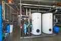 The interior of a modern gas boiler house with pumps, valves, a