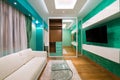 Interior of a modern green living room with luxury ceiling light Royalty Free Stock Photo