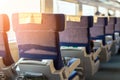 Interior of modern intercity express train. Back view of wide comfortable seats in row at railroad transport Royalty Free Stock Photo