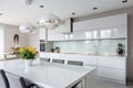 interior of modern kitchen with white furniture and dining area, nobody inside Royalty Free Stock Photo