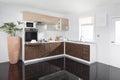 Interior of a modern kitchen, wooden furniture, simple and clean Royalty Free Stock Photo