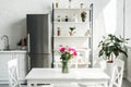interior of modern light kitchen with bouquet of tulips Royalty Free Stock Photo
