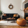 Interior of modern living room with comfortable sofa chair table and pumpkins Royalty Free Stock Photo