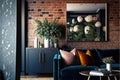 The interior of a modern living room with a dark blue sofa next to a brick wall on which a horizontal poster hangs, in the Royalty Free Stock Photo