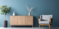 Interior of modern living room with gray wooden sideboard over blue wall. Contemporary room with armchair. Home design