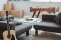 interior of modern living room with guitar, armchairs, table football and table with joysticks