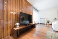 Interior of a modern living room with shiny wall of lacquered wood