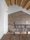 Interior of a modern living room with wooden bookcase in the mansard