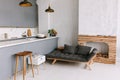 Interior of the modern loft kitchen-studio in the apartment. Room, furniture, sofa near wooden fireplace Royalty Free Stock Photo