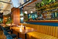Interior of modern loft style restaurant with fresh flowers and mirror Royalty Free Stock Photo