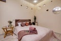 Interior of modern luxure bedroom in studio apartments in light pink color style Royalty Free Stock Photo