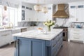 Interior of modern luxurious kitchen classic style. White and blue cabinets with gilded handles, kitchen island with Royalty Free Stock Photo