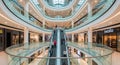 Interior of a Modern Multi- Level Shopping Mall with Escalators and Shoppers architecture Royalty Free Stock Photo
