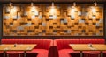 Modern restaurant interior with red booth seating and textured wood panel wall dining Royalty Free Stock Photo