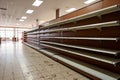 Interior of a modern shopping mall with rows of empty shelves, Food shortage in a generic supermarket. Empty shelves, AI Generated