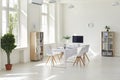 Interior of a modern white business office. Empty light spacious conference room in office with desk, chairs and Royalty Free Stock Photo