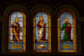 interior of the nave of the Basilica sacro cuore,3 stained glass windows of saints, Rome, Italy.