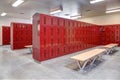 A high school locker room with metal lockers, and wood benches. Royalty Free Stock Photo