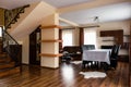 Interior of a nicely furnished living room with a staircase in a modern apartment