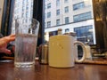 Interior of NYC diner with coffee cup and water glass on table window