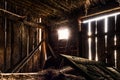 The interior of an old abandoned barn. Clutter, junk. Interesting lighting Royalty Free Stock Photo